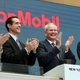Exxon CEO Darren Woods (second from right) clapping at the New York Stock Exchange because money.